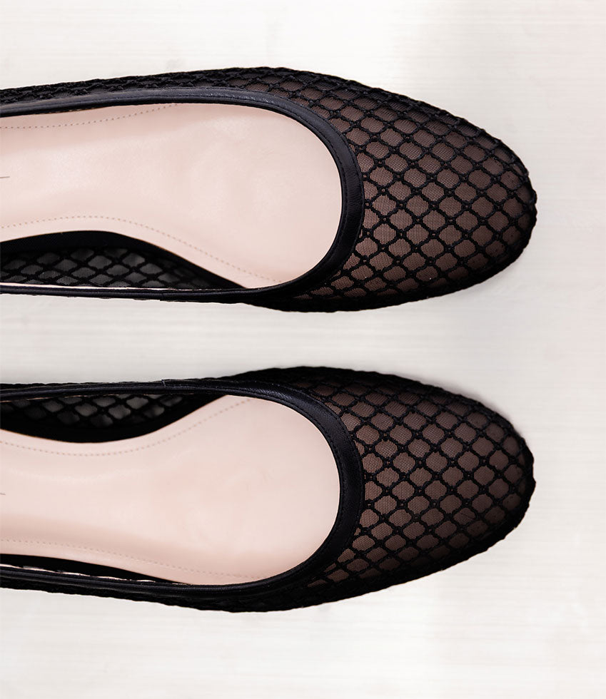 Black FIORA ballet flats on a white background