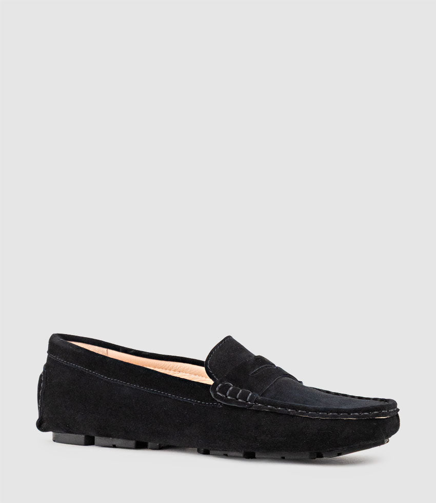 Black loafer shoe on a light grey background