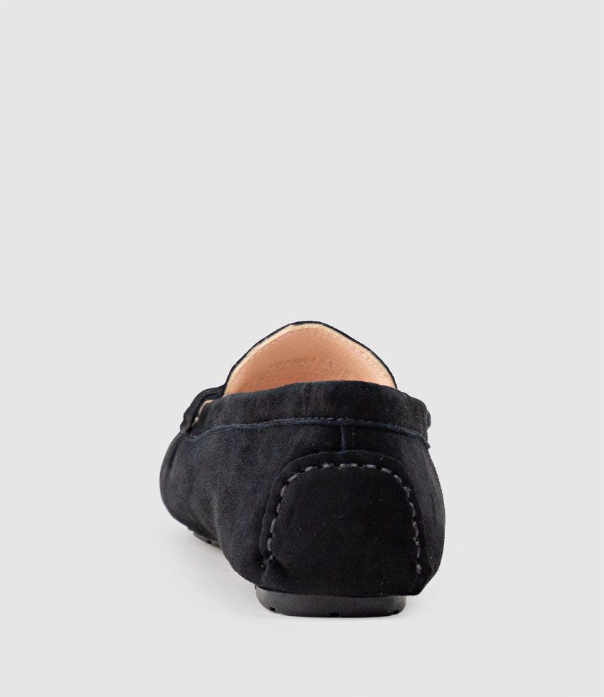 Black loafer shoe on a light grey background