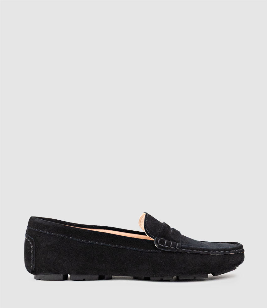 Black loafer shoe on a light grey background