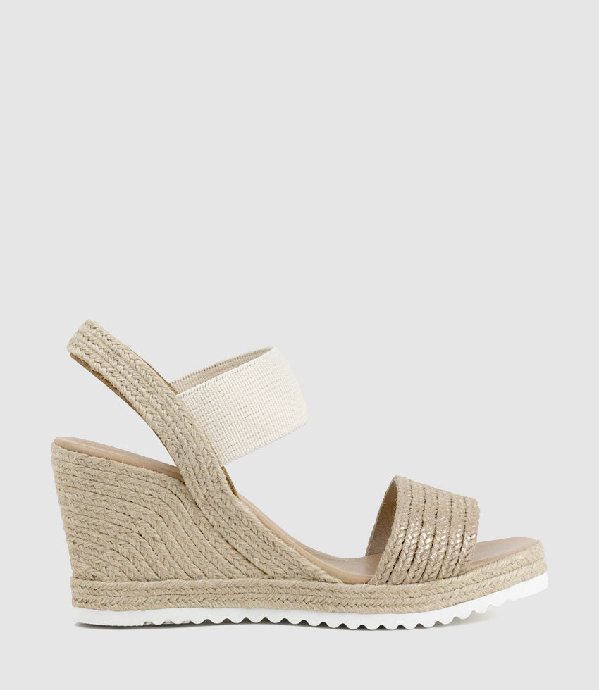 Beige wedge sandal with espadrille sole on a light gray background