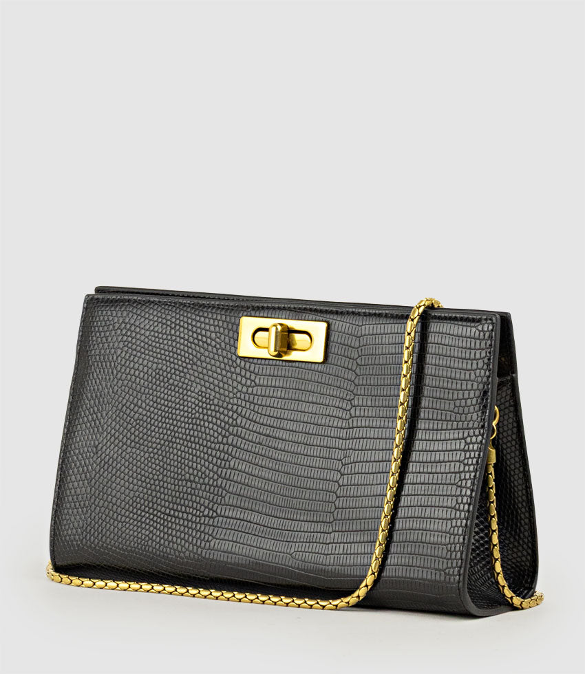 NAYLA Bag with Twist Hardware in Black Tejus Lizard Print - Edward Meller