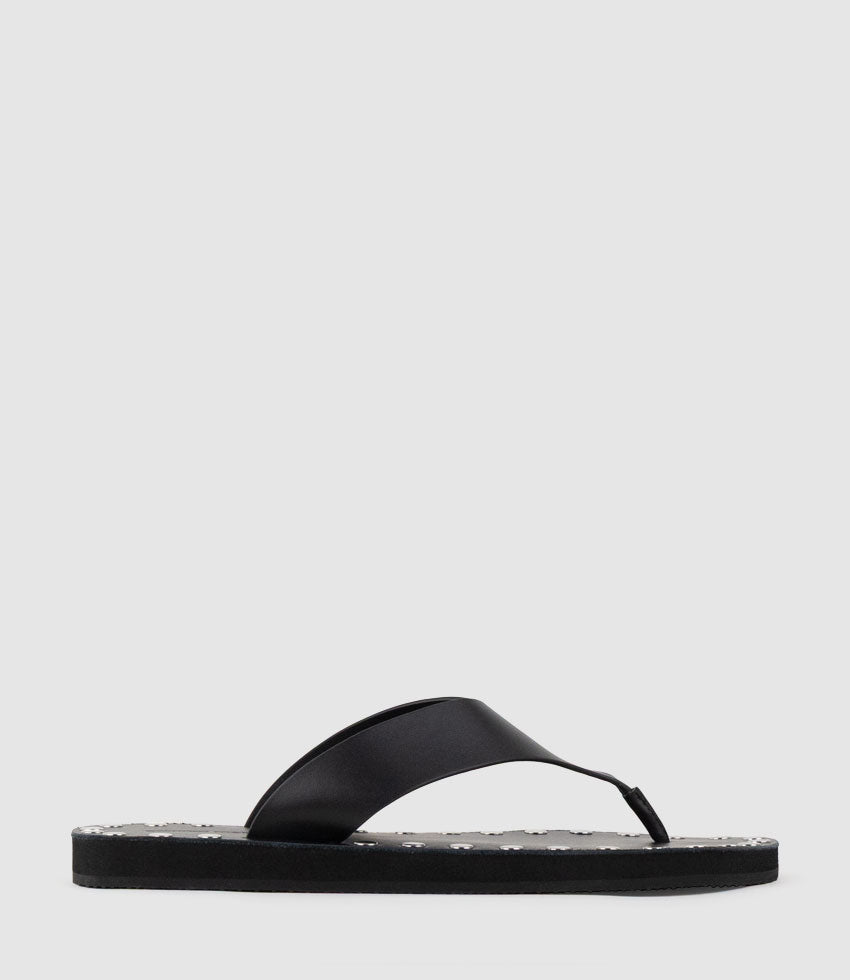 THEA Leather Thong on Studded Sole in Black - Edward Meller