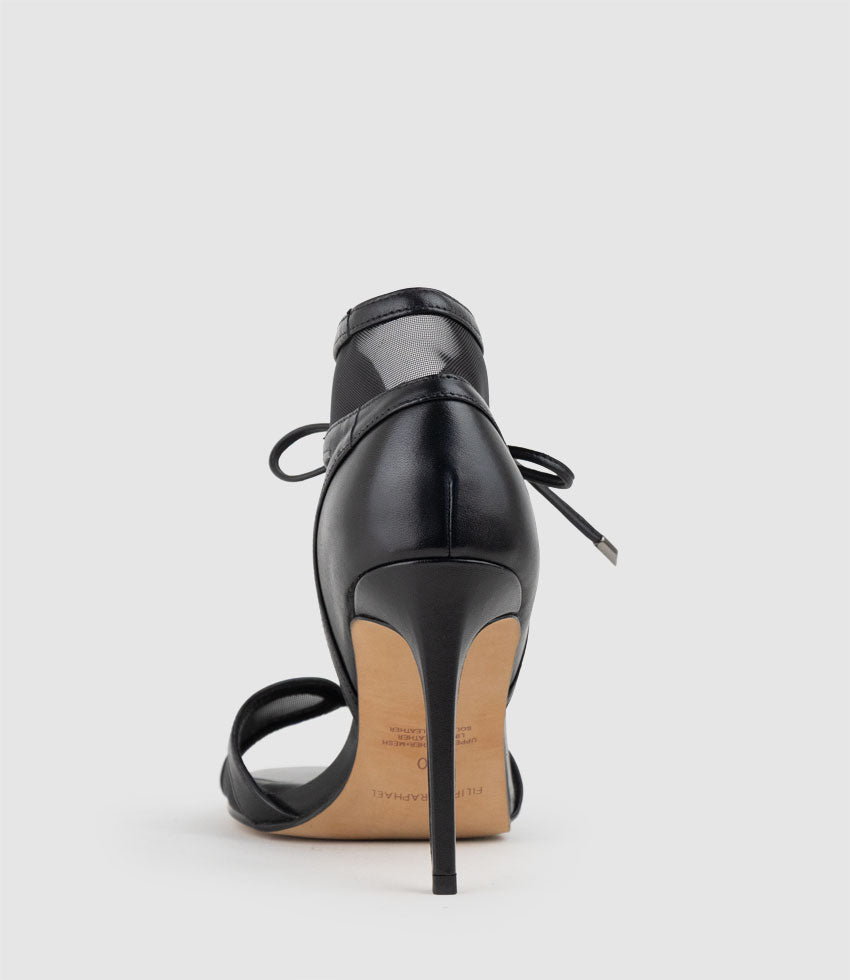 Black high-heeled shoe on a white background